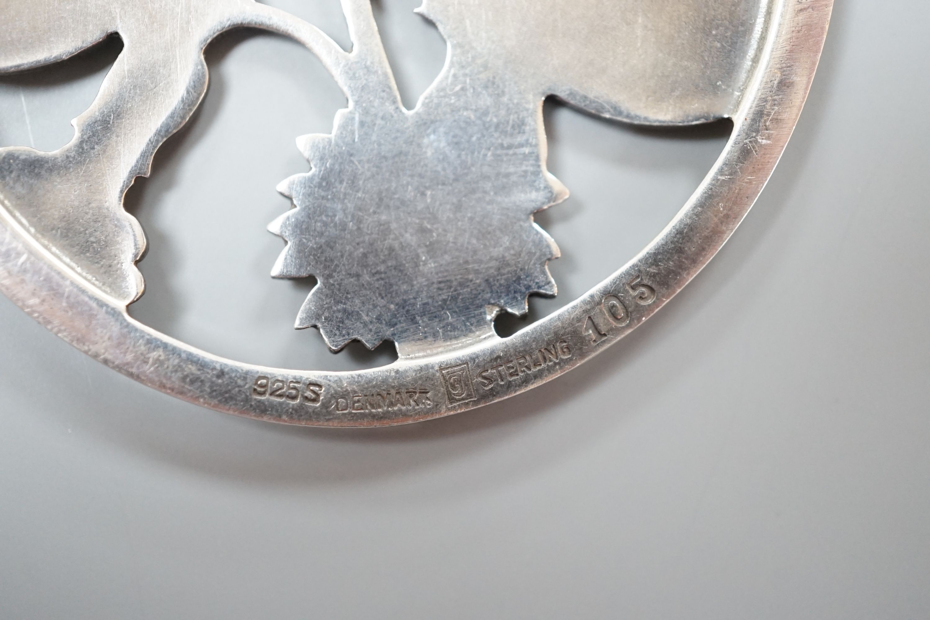 A George Jensen (designed by Arno Malinowski) sterling 'twin moth amid foliage' circular pendant necklace, no. 105, pendant diameter 51mm, chain 54cm.